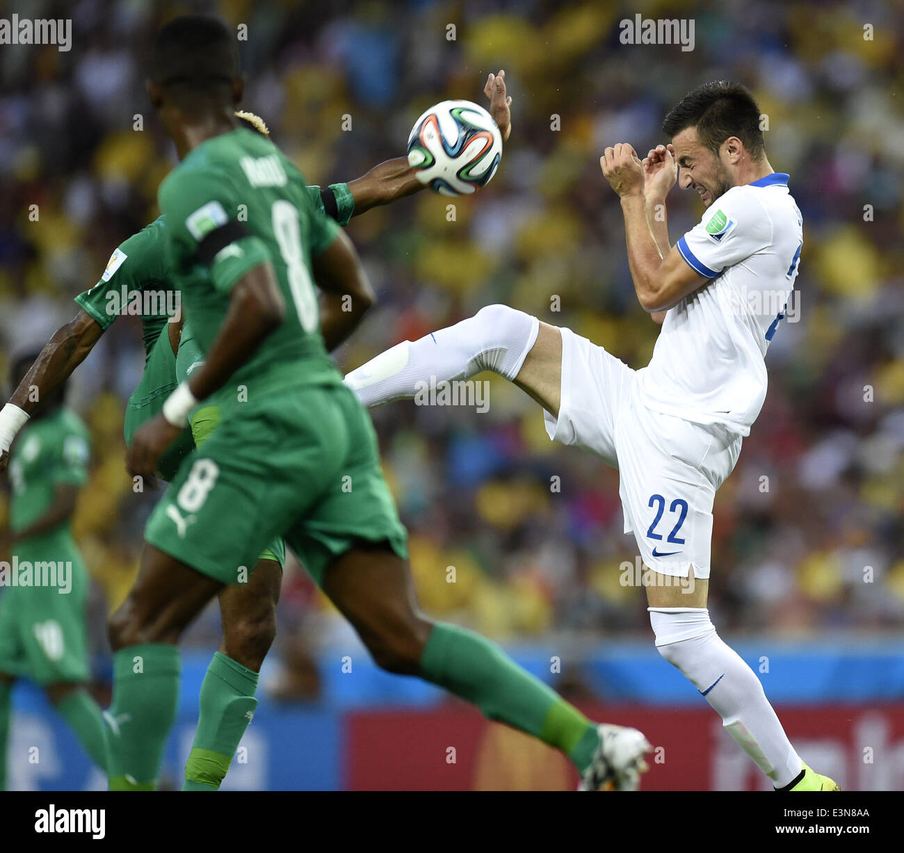 Fortaleza, Brazil. 24th June, 2014. Greece's Andreas Samaris (R) competes during a Group C match between Greece and Cote d'Ivoire of 2014 FIFA World Cup at the Estadio Castelao Stadium in Fortaleza, Brazil, June 24, 2014. Credit:  Yang Lei/Xinhua/Alamy Live News Stock Photo