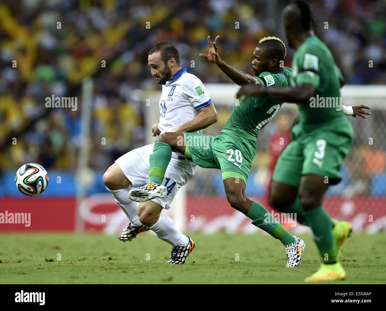 Fortaleza, Brazil. 24th June, 2014. Greece's Dimitris Salpingidis (L) vies with Cote d'Ivoire's Geoffroy Serey Die (C) during a Group C match between Greece and Cote d'Ivoire of 2014 FIFA World Cup at the Estadio Castelao Stadium in Fortaleza, Brazil, June 24, 2014. Credit:  Yang Lei/Xinhua/Alamy Live News Stock Photo