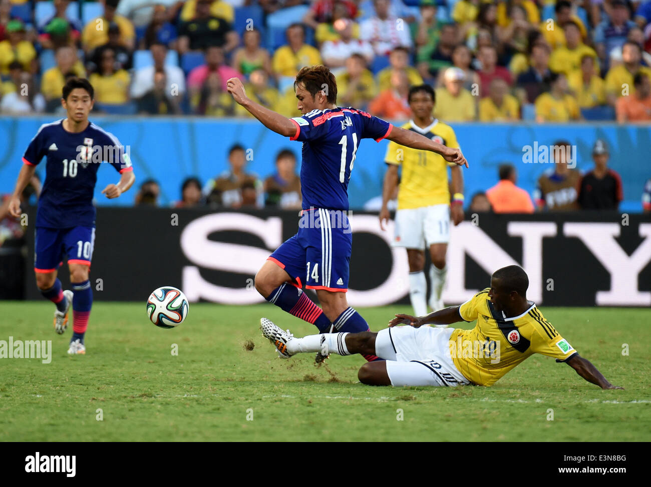 Cuiaba, Brazil. 24th June, 2014. Japan's Toshihiro Aoyama (2nd L) vies for the ball with Colombia's Adrian Ramos during a Group C match between Japan and Colombia of 2014 FIFA World Cup at the Arena Pantanal Stadium in Cuiaba, Brazil, June 24, 2014. © Liu Dawei/Xinhua/Alamy Live News Stock Photo