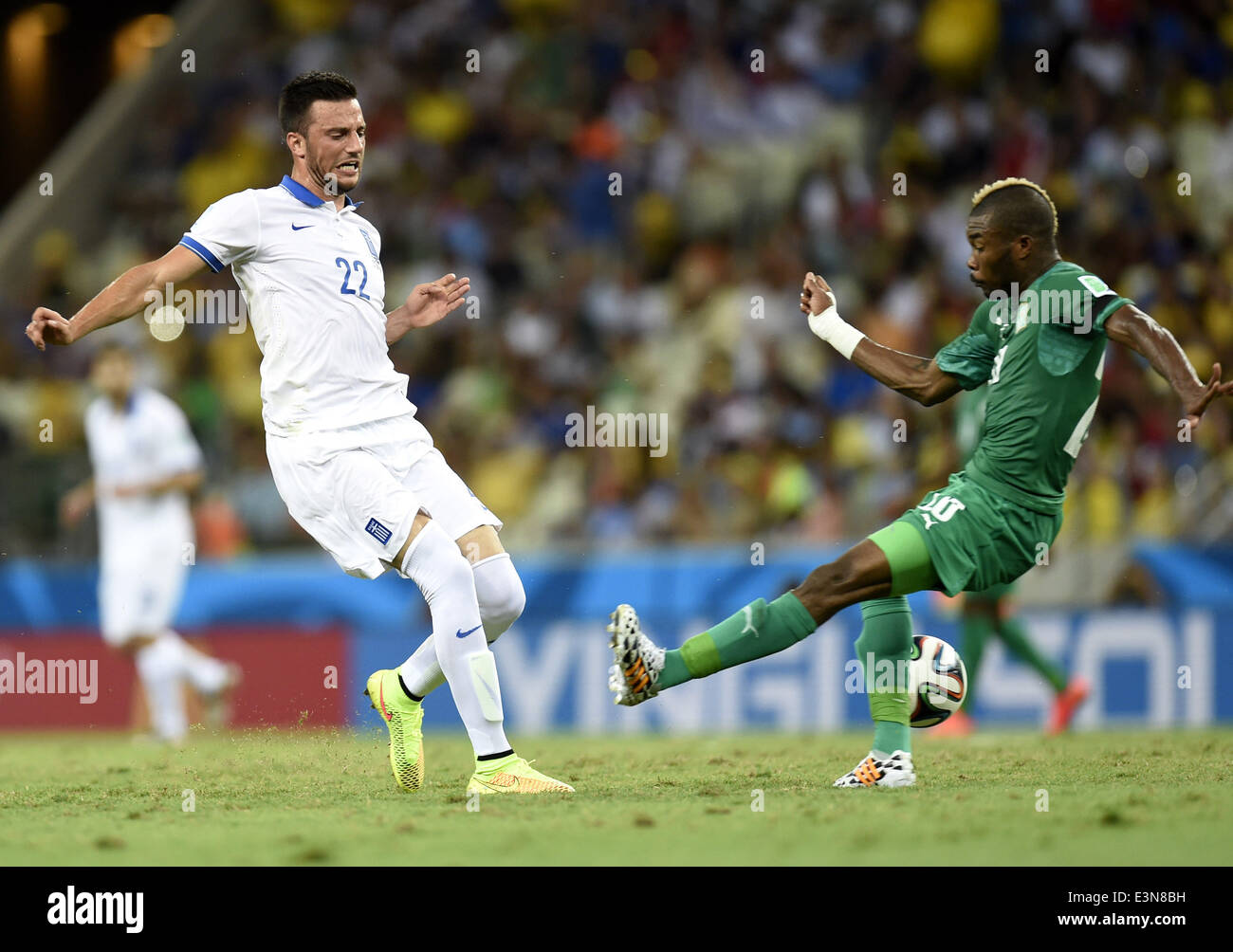 Fortaleza, Brazil. 24th June, 2014. Greece's Andreas Samaris (L) shoots during a Group C match between Greece and Cote d'Ivoire of 2014 FIFA World Cup at the Estadio Castelao Stadium in Fortaleza, Brazil, June 24, 2014. Credit:  Yang Lei/Xinhua/Alamy Live News Stock Photo