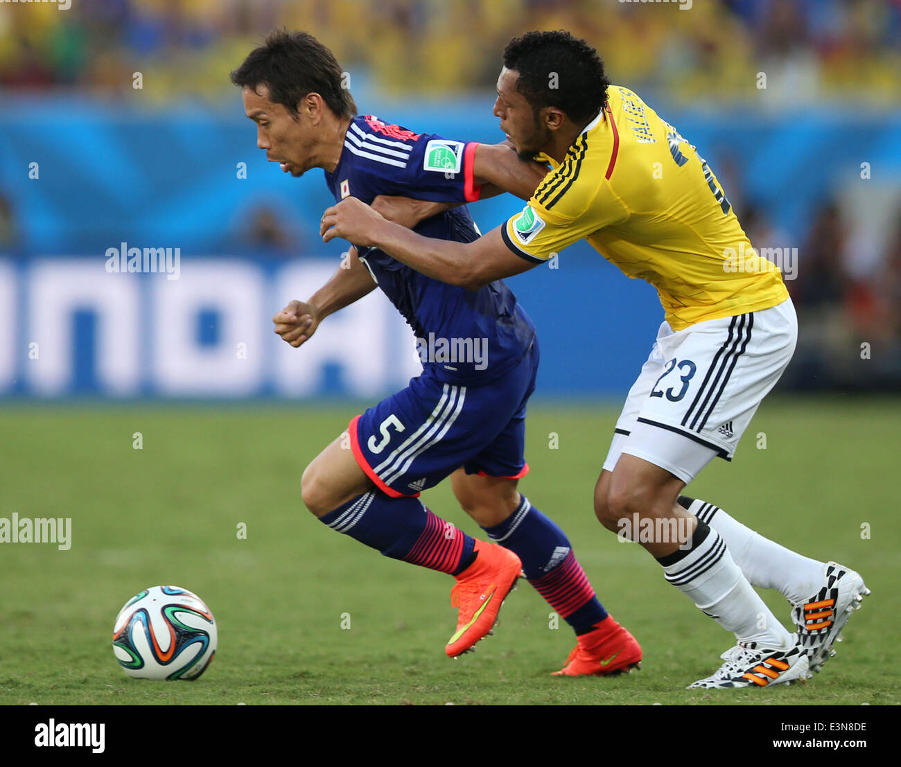 Cuiaba, Brazil. 24th June, 2014. Japan's Yuto Nagatomo vies with Colombia's Carlos Valdes during a Group C match between Japan and Colombia of 2014 FIFA World Cup at the Arena Pantanal Stadium in Cuiaba, Brazil, June 24, 2014. © Liu Dawei/Xinhua/Alamy Live News Stock Photo