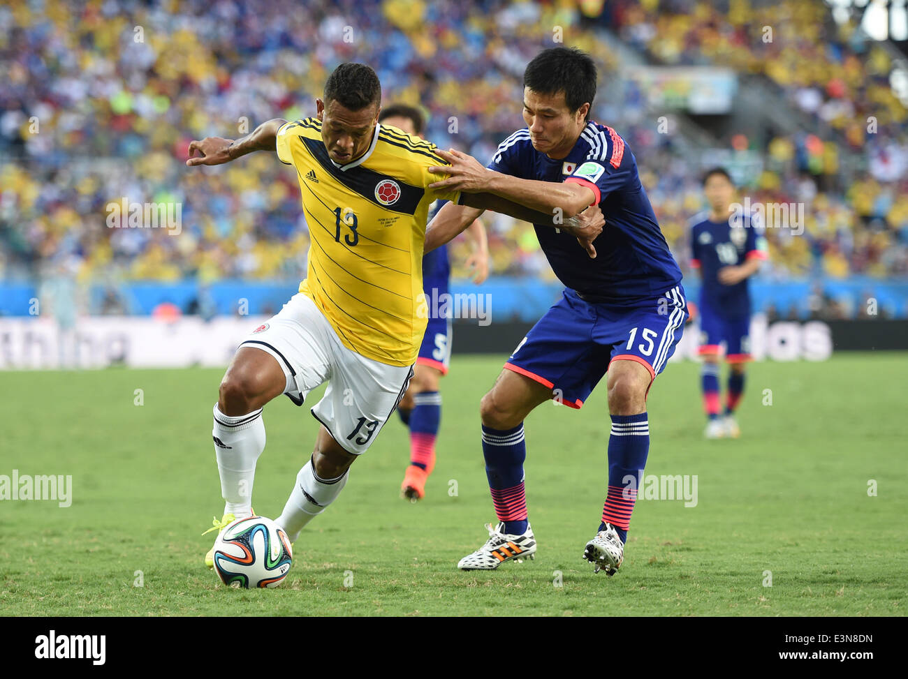Cuiaba, Brazil. 24th June, 2014. Japan's Masahiko Inoha vies with Colombia's Freddy Guarin during a Group C match between Japan and Colombia of 2014 FIFA World Cup at the Arena Pantanal Stadium in Cuiaba, Brazil, June 24, 2014. © Liu Dawei/Xinhua/Alamy Live News Stock Photo