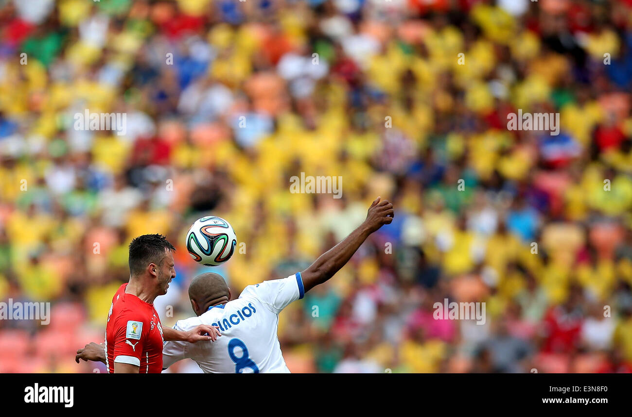 Manaus, Brazil. 25th June, 2014. Honduras' Wilson Palacios (R) competes for a header with Switzerland's Josip Drmic during a Group E match between Honduras and Switzerland of 2014 FIFA World Cup at the Arena Amazonia Stadium in Manaus, Brazil, on June 25, 2014. Switzerland won 3-0 over Honduras on Wednesday. Credit:  Li Ming/Xinhua/Alamy Live News Stock Photo
