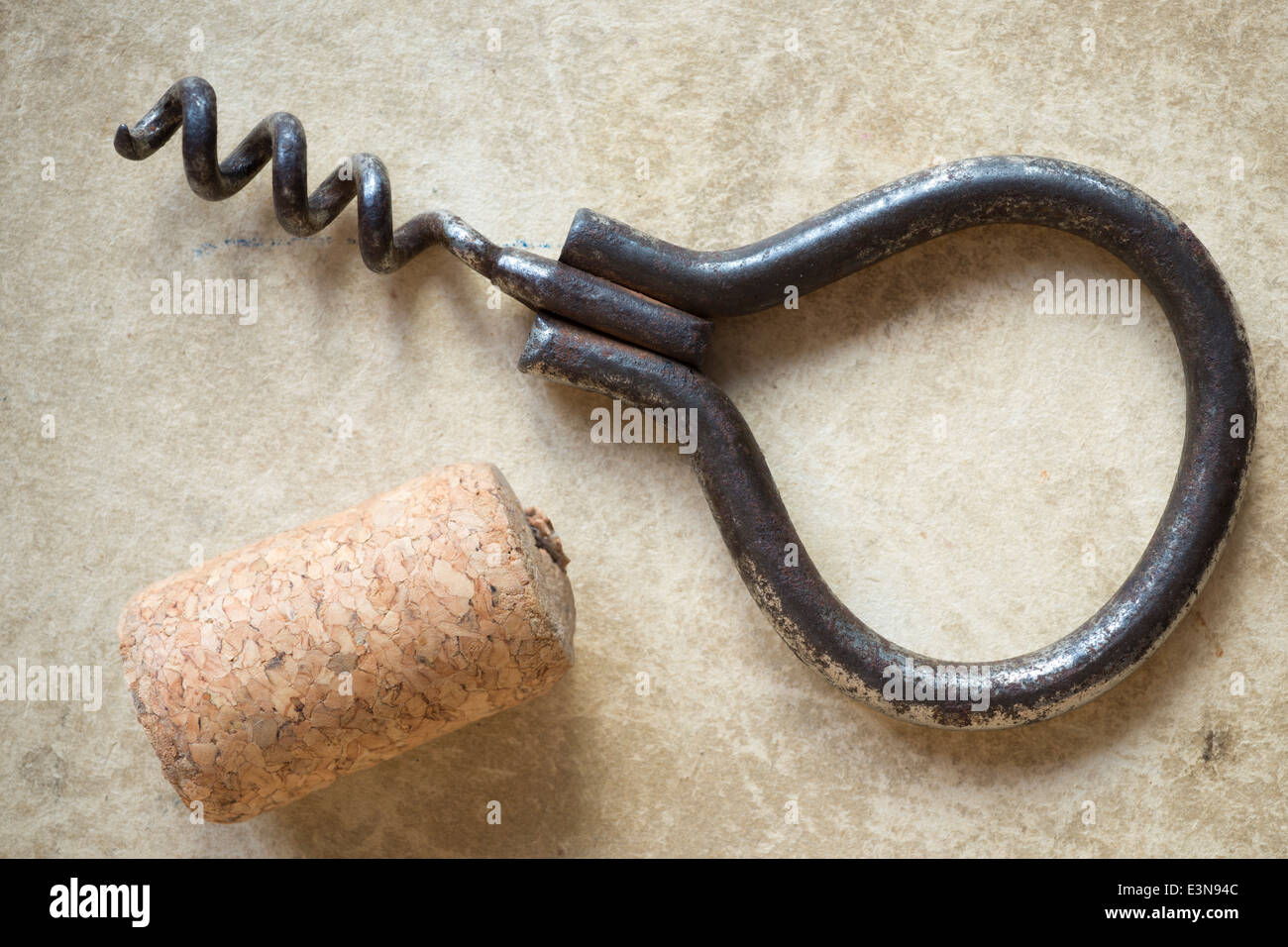 vintage corkscrew with cork on old cardboard background Stock Photo