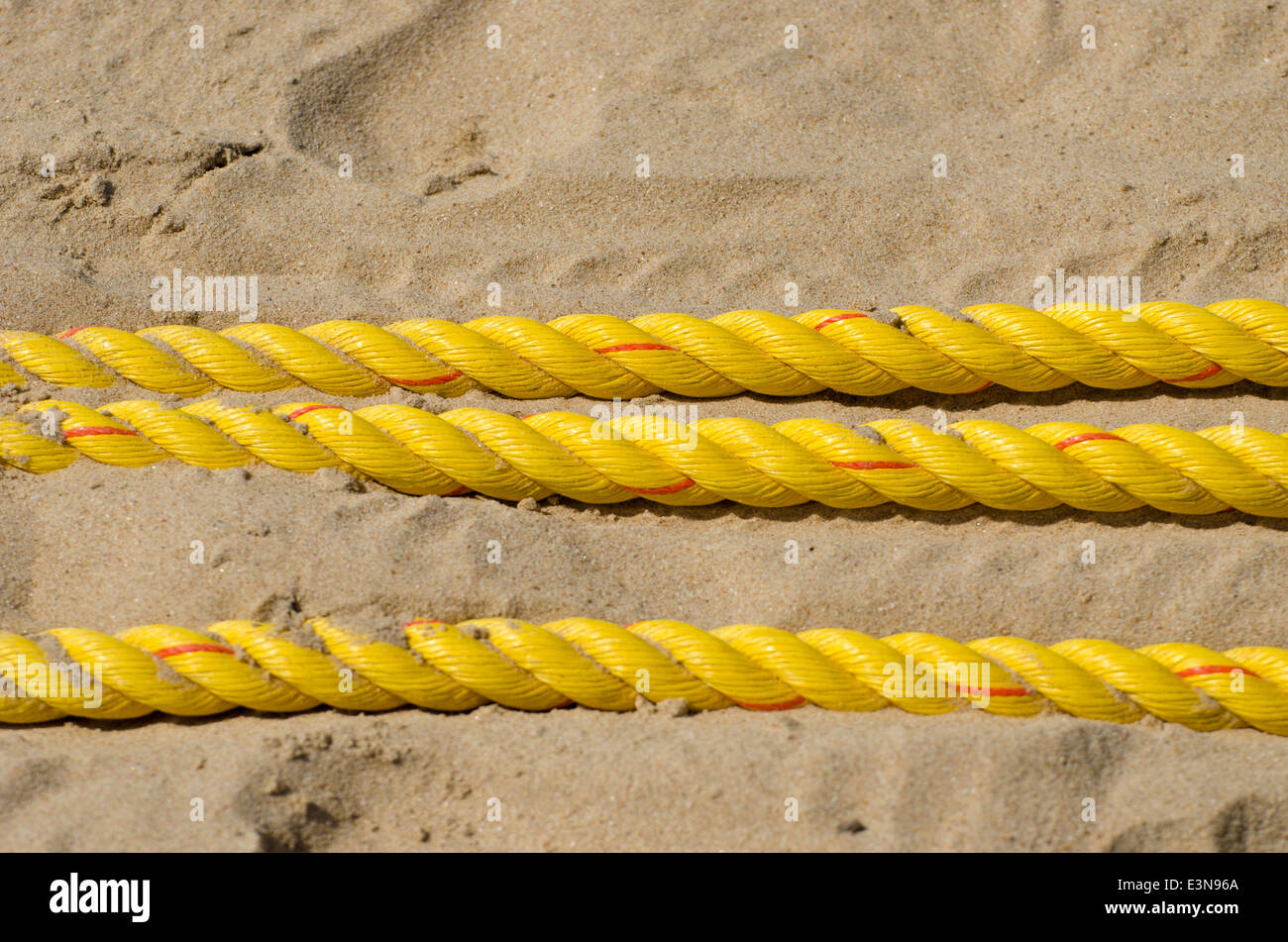 yellow ropes on summer resort beach sand Stock Photo - Alamy