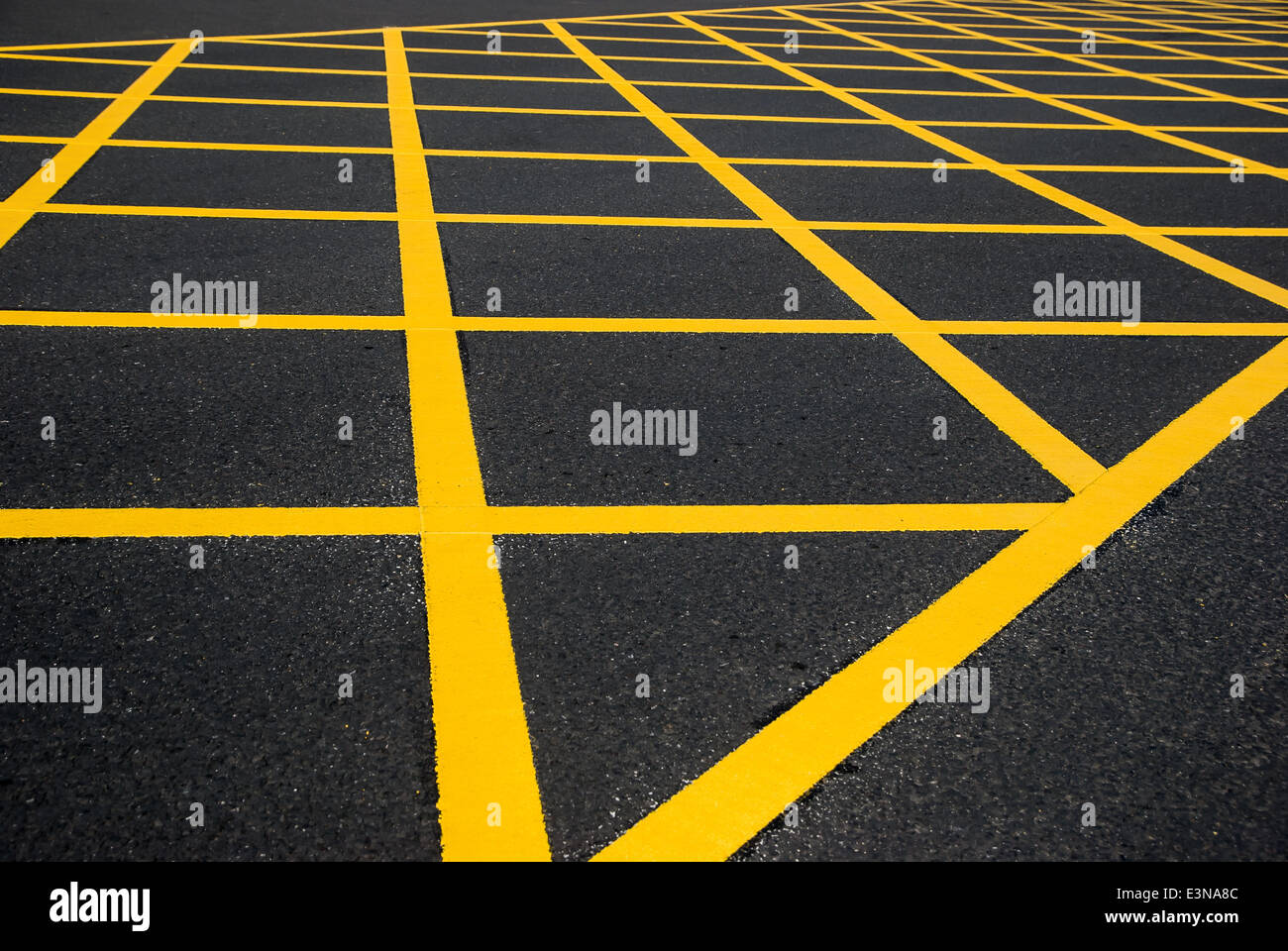 cross yellow lines on blacktop Stock Photo Alamy