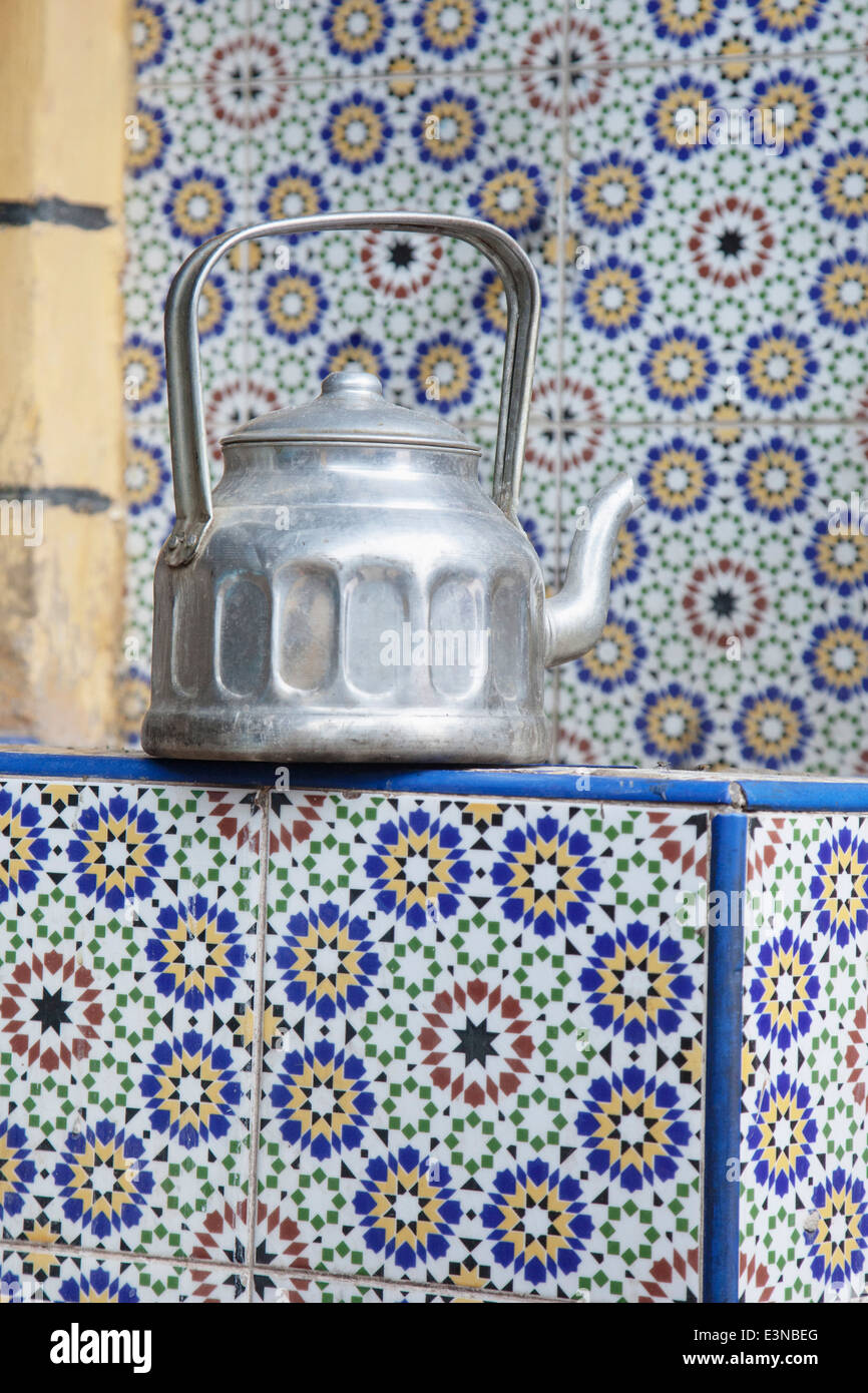 Old tea kettle on tiled counter Stock Photo