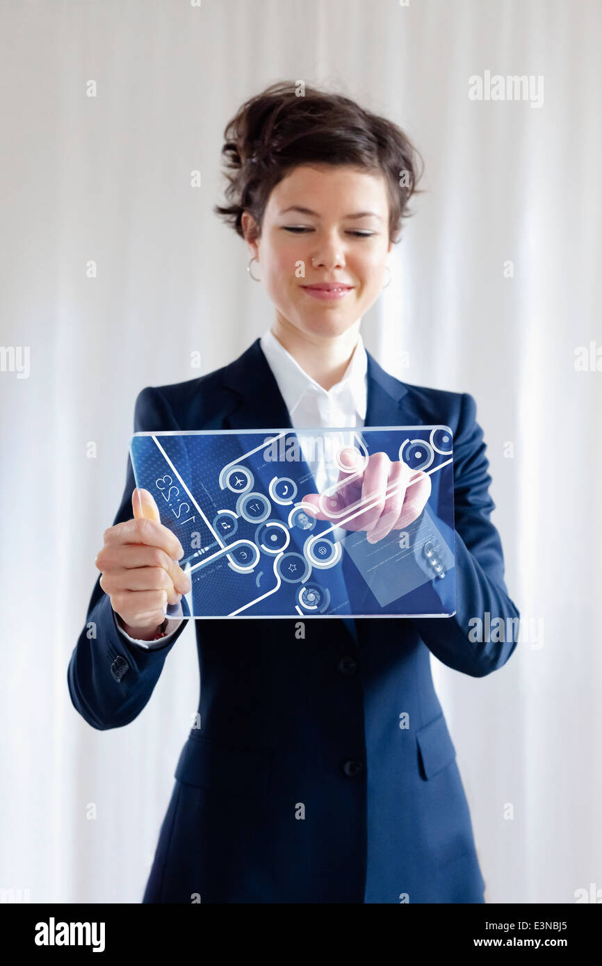 Portrait Of Smiling Businesswoman Using Futuristic Digital Tablet Stock Photo