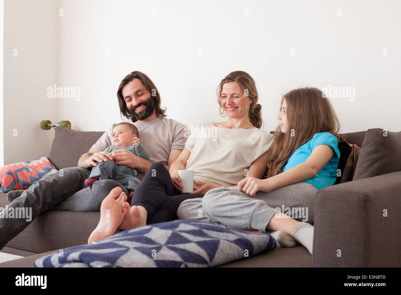 Happy family spending leisure time in living room Stock Photo