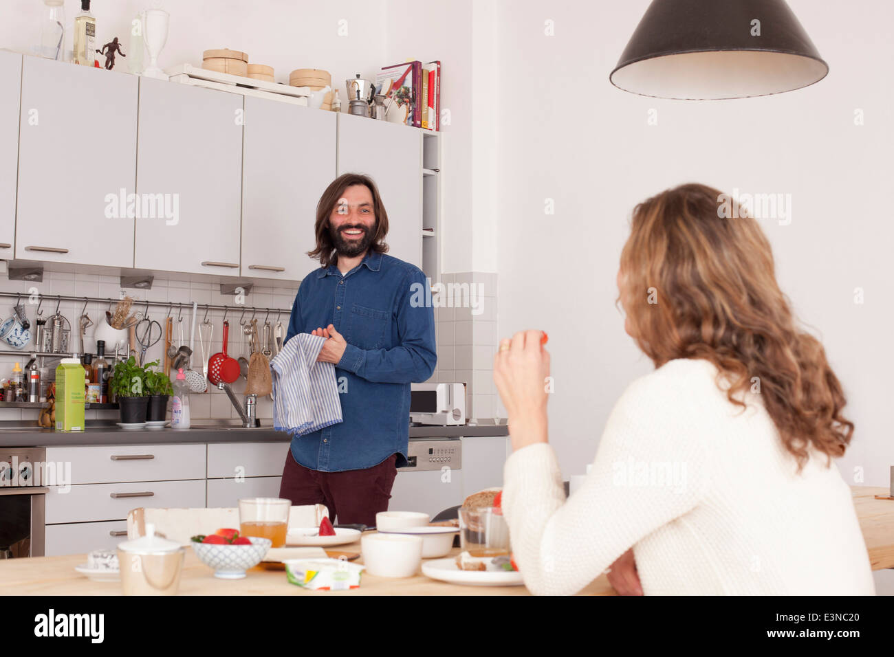 Smiling mid adult couple in kitchen Stock Photo