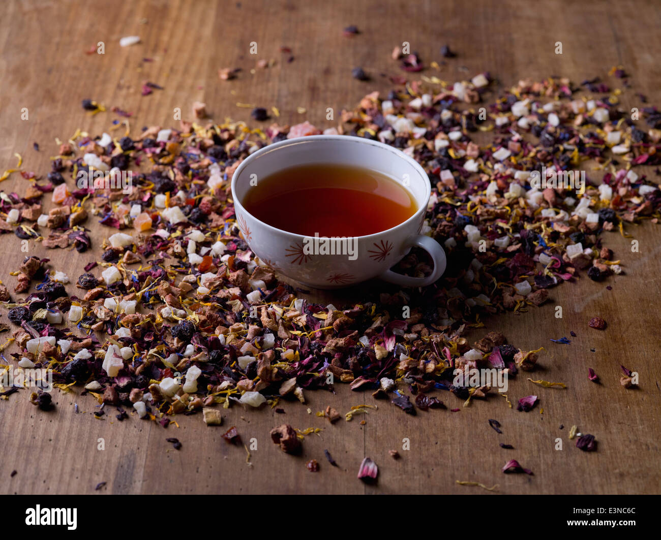 Tea cup amidst herbs on wooden table Stock Photo