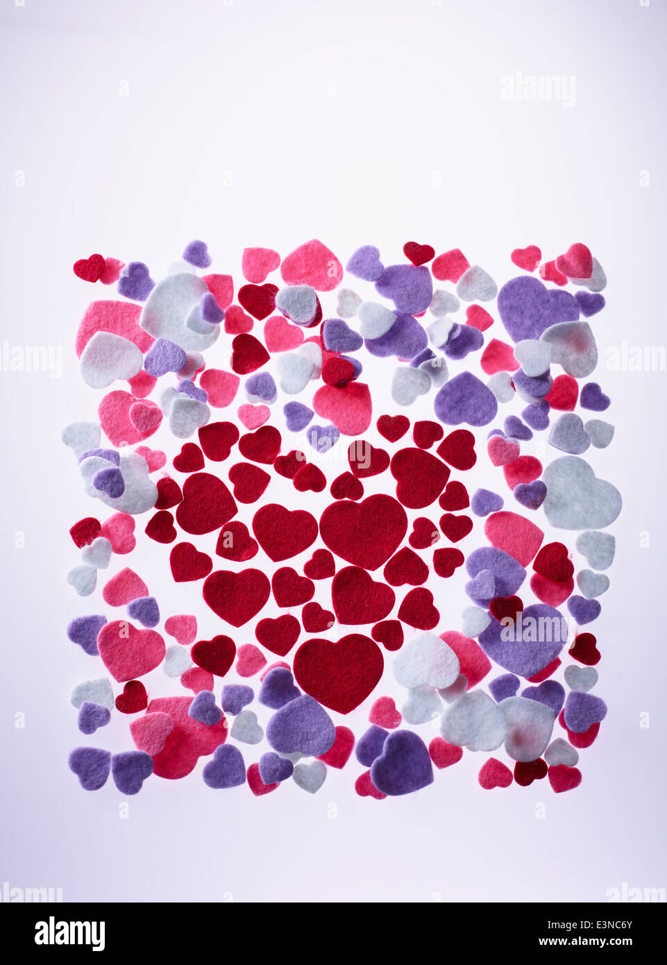 Various velvet hearts over colored background Stock Photo