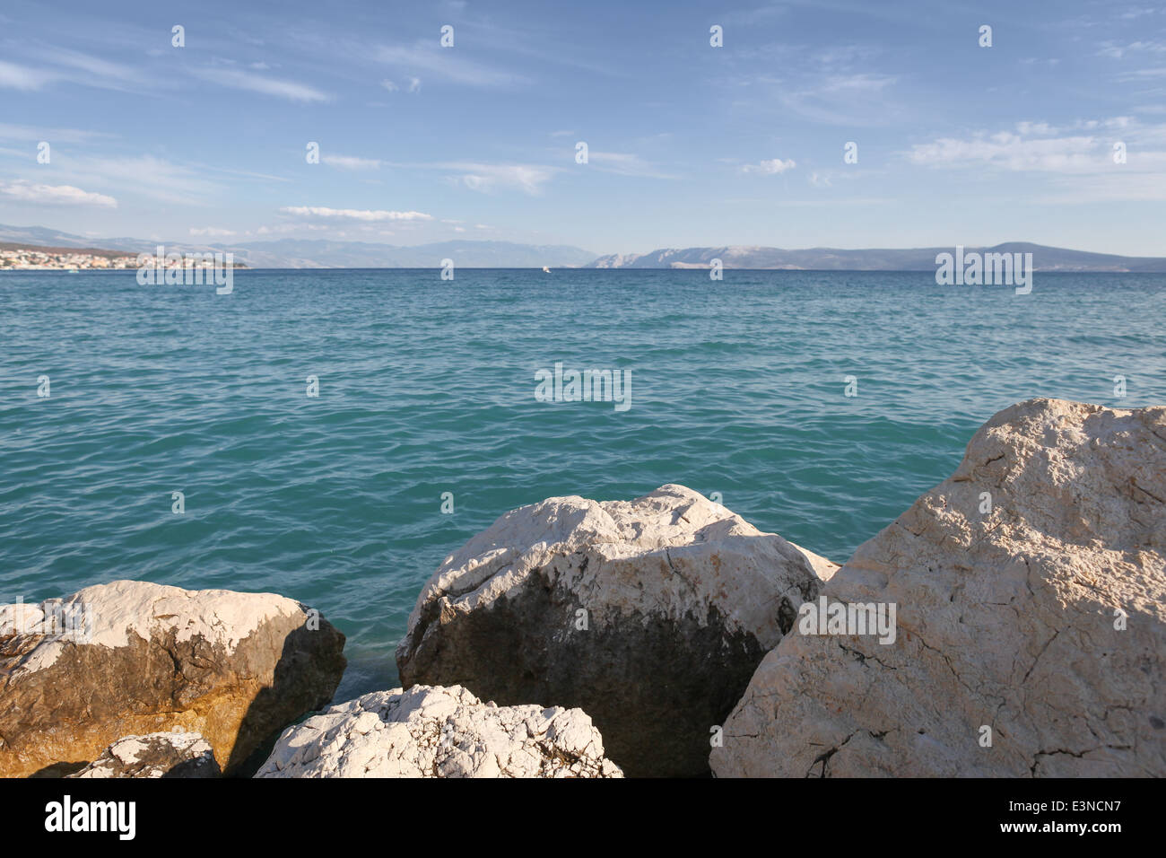 Croatian landscape with boulders, Adriatic Sea and mountains, seen from the beach in Crikvenica. Focus on the boulders Stock Photo