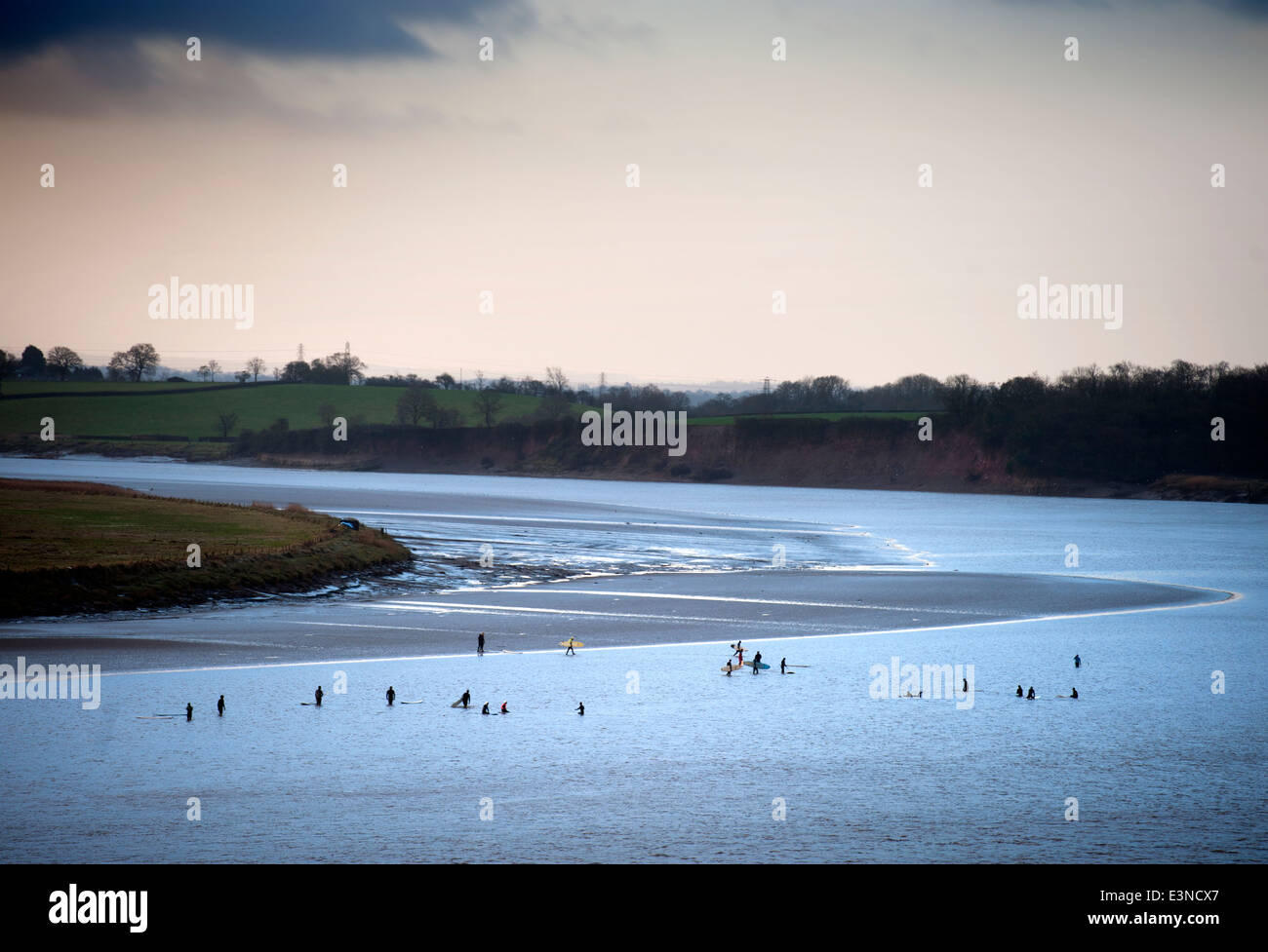 Surfers and canoeists waiting for the approaching Severn Bore tidal wave at Newnham-on-Severn, Gloucestershire UK 2014 Stock Photo