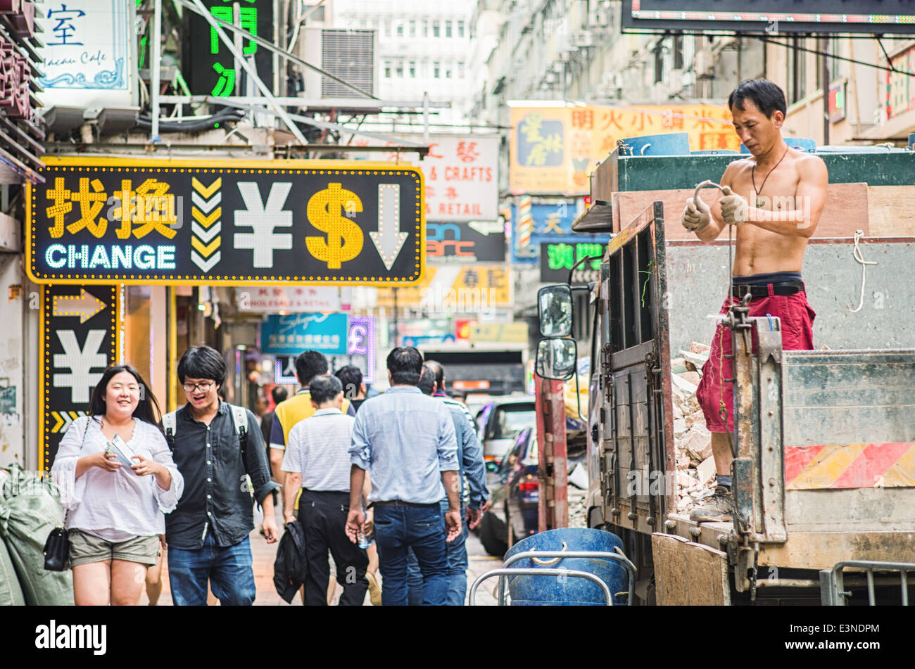 Hong Kong busy street scene with pedestrians and people at work Stock