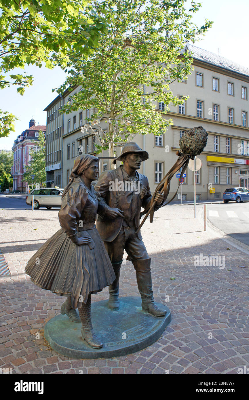 Bronze statue of couple in traditional dress in Villach, Austria Stock Photo