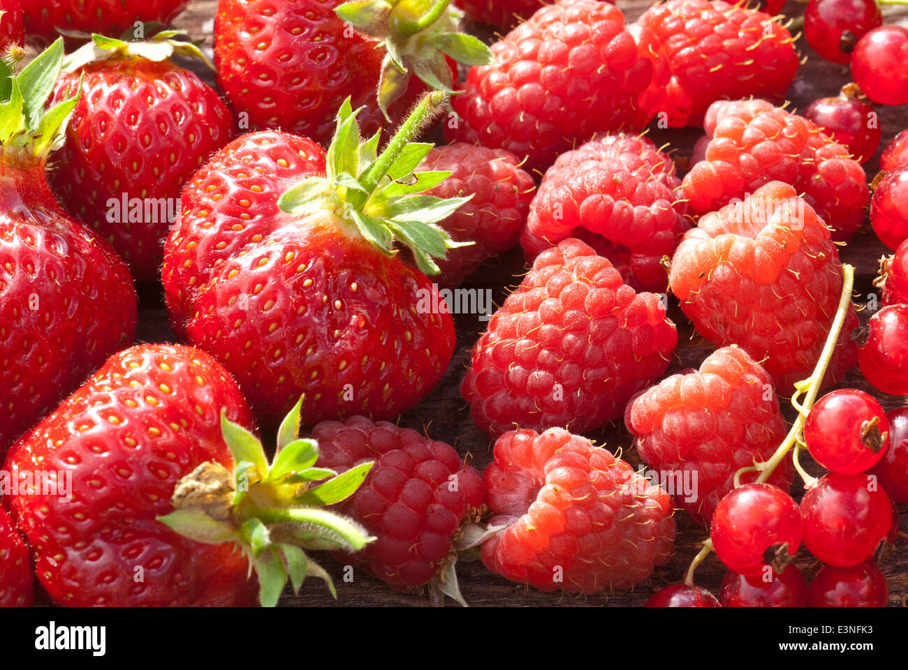 Mixed soft summer fruits - strawberries, raspberries and red currants Stock Photo