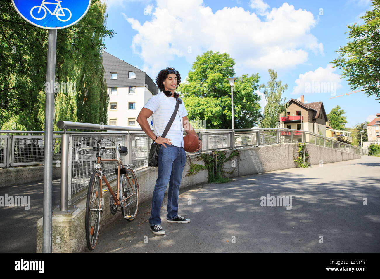 portrait of young male student with a bicycle in the town Stock Photo