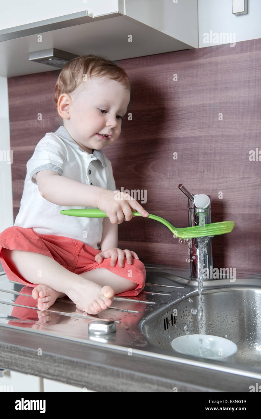 a 1,5 years old boy playing in the kitchen Stock Photo Alamy