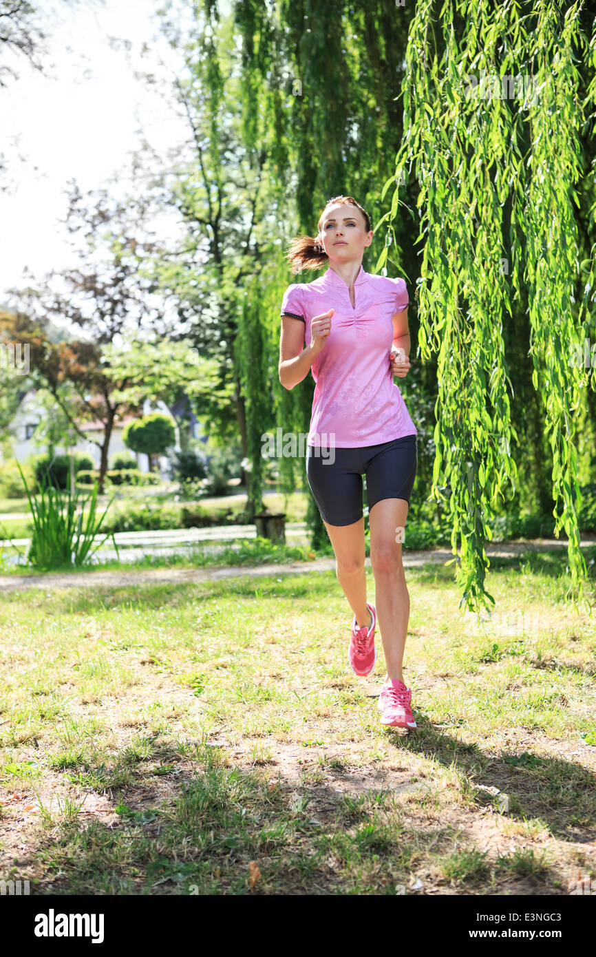 young woman jogging in a park or forest Stock Photo - Alamy