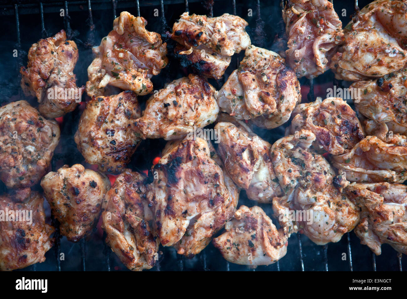 Grilling chicken in closeup Stock Photo