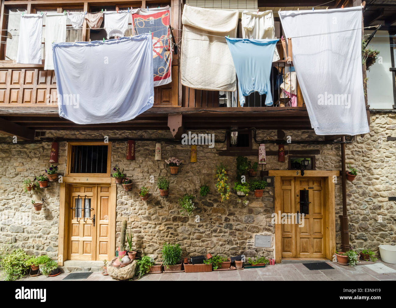 Washing hung out to dry on a line outside a traditional stone house in Potes, Cantabria, Spain Stock Photo