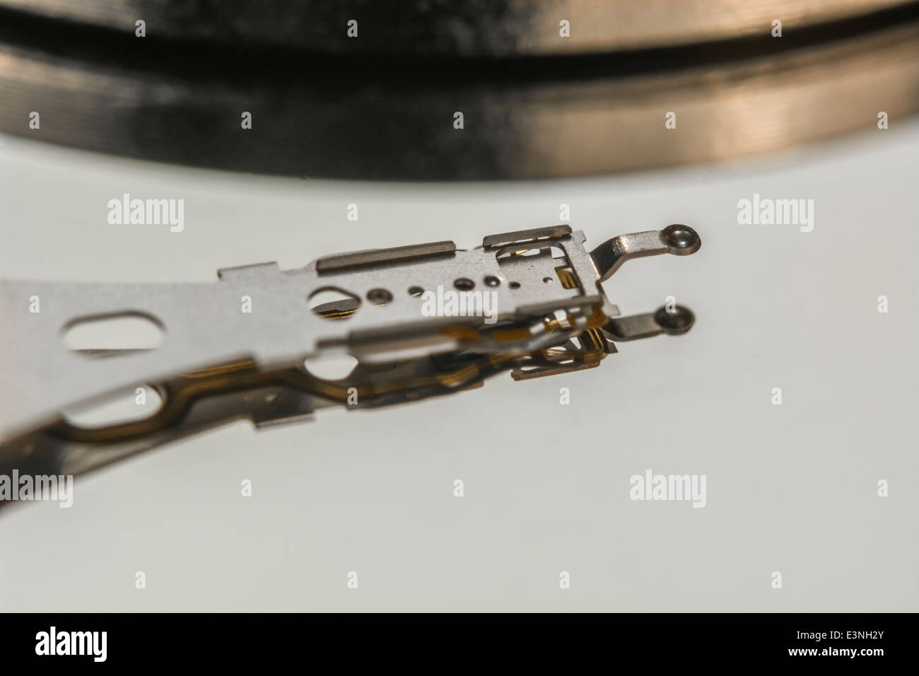 Macro-photo of HDD read-write head and armature over drive platter. For ...