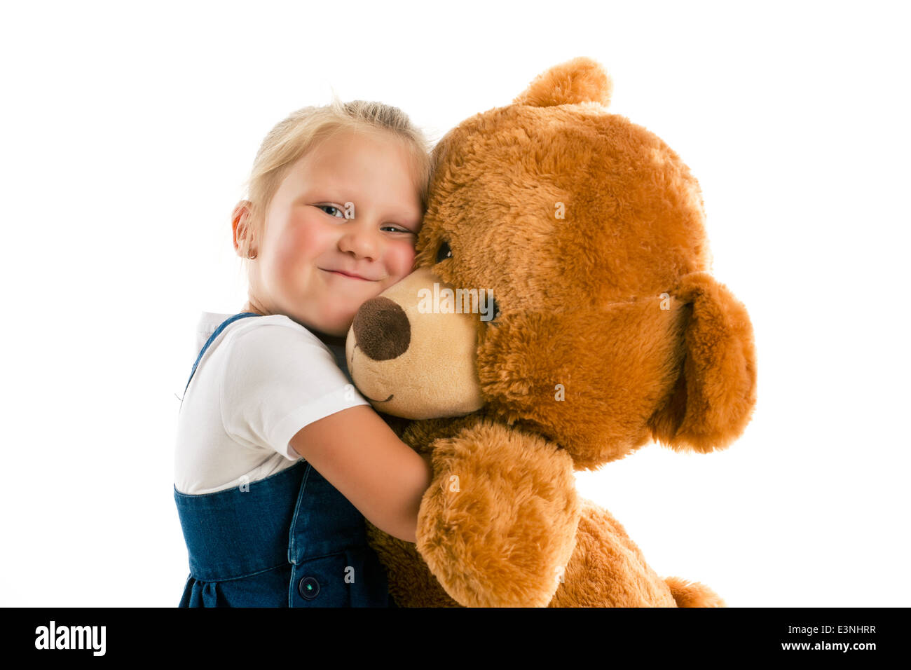 kid hugging teddy bear