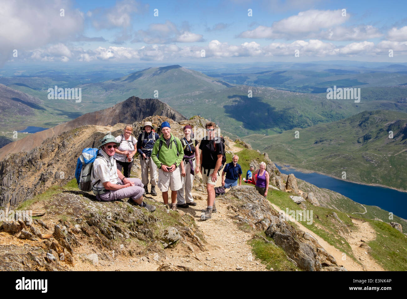 Happy group of hikers on Crib y Ddysgl after walking across Crib Goch ridge in Snowdon Horseshoe. Snowdonia National Park Wales UK Britain Stock Photo