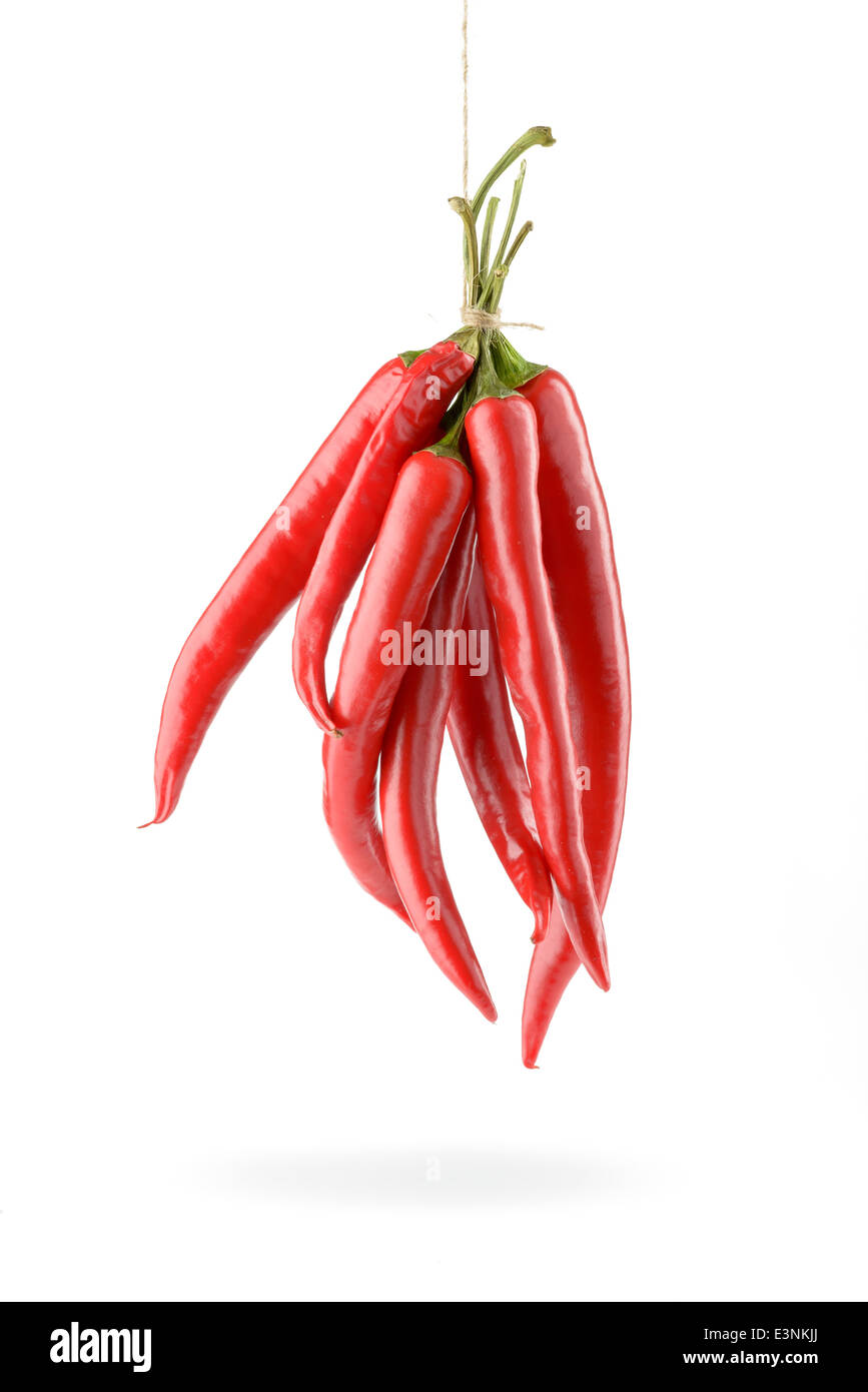 Hanged hot red chili peppers isolated on white background Stock Photo
