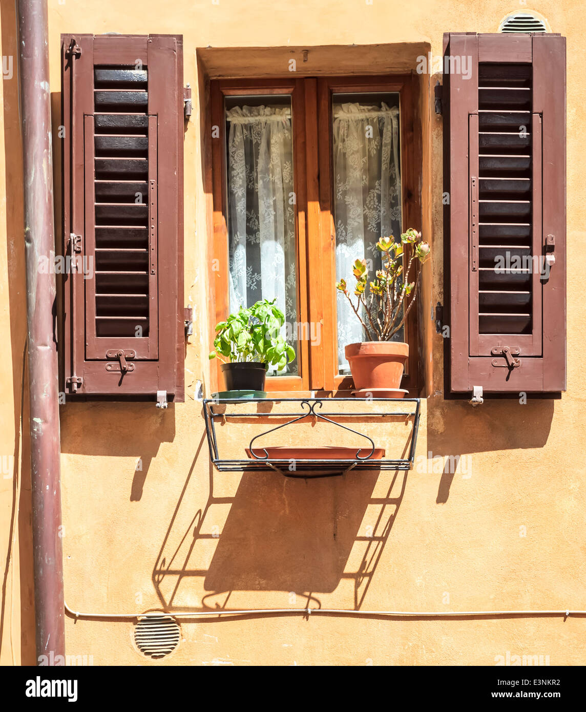 Castellina in Chianti street scene, Tuscany, Italy: bright painted brown shutters Stock Photo