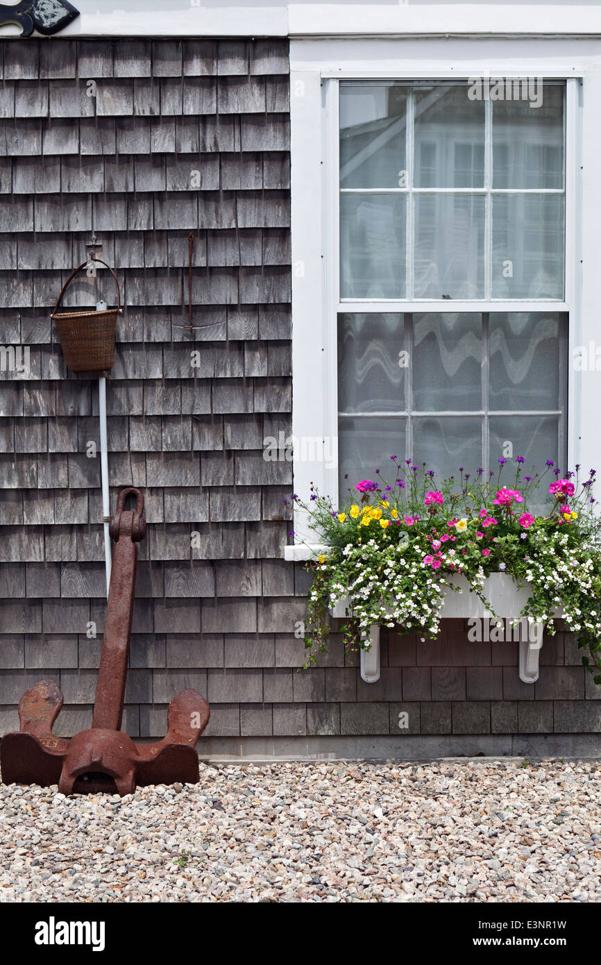 Exterior detail of shingle cottage decorated with flowerbox and ship's anchor Nantucket Town Nantucket Massachusetts USA Stock Photo