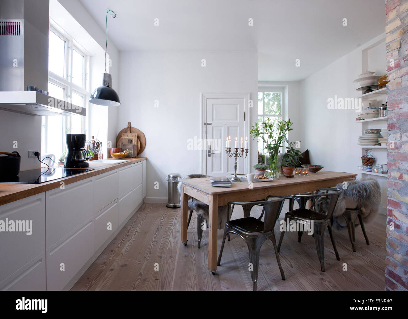 Open Plan Kitchen With Wall Shelving And Window Seat Stock Photo