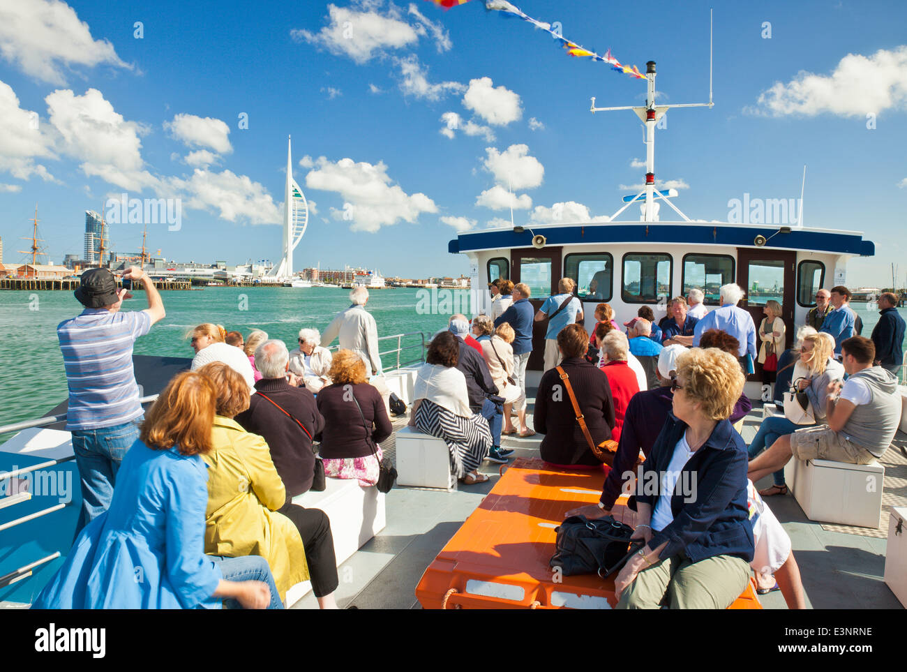 Tourists on a harbour boat trip around Portsmouth Harbour. Stock Photo