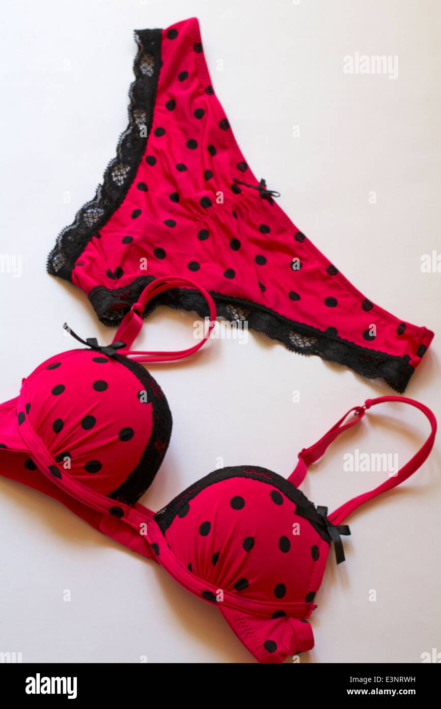 matching sexy polka dot pink coloured with black lace edged underwear set -  bra and knickers set on white background Stock Photo - Alamy