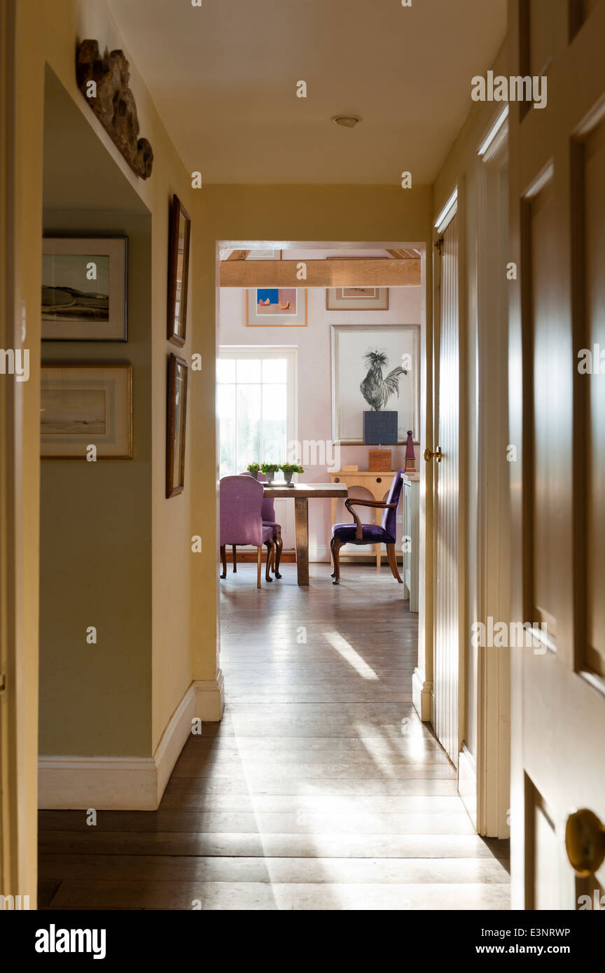 View through corridor to dining room with cockerel painting by Michelle Pearson Cooper Stock Photo