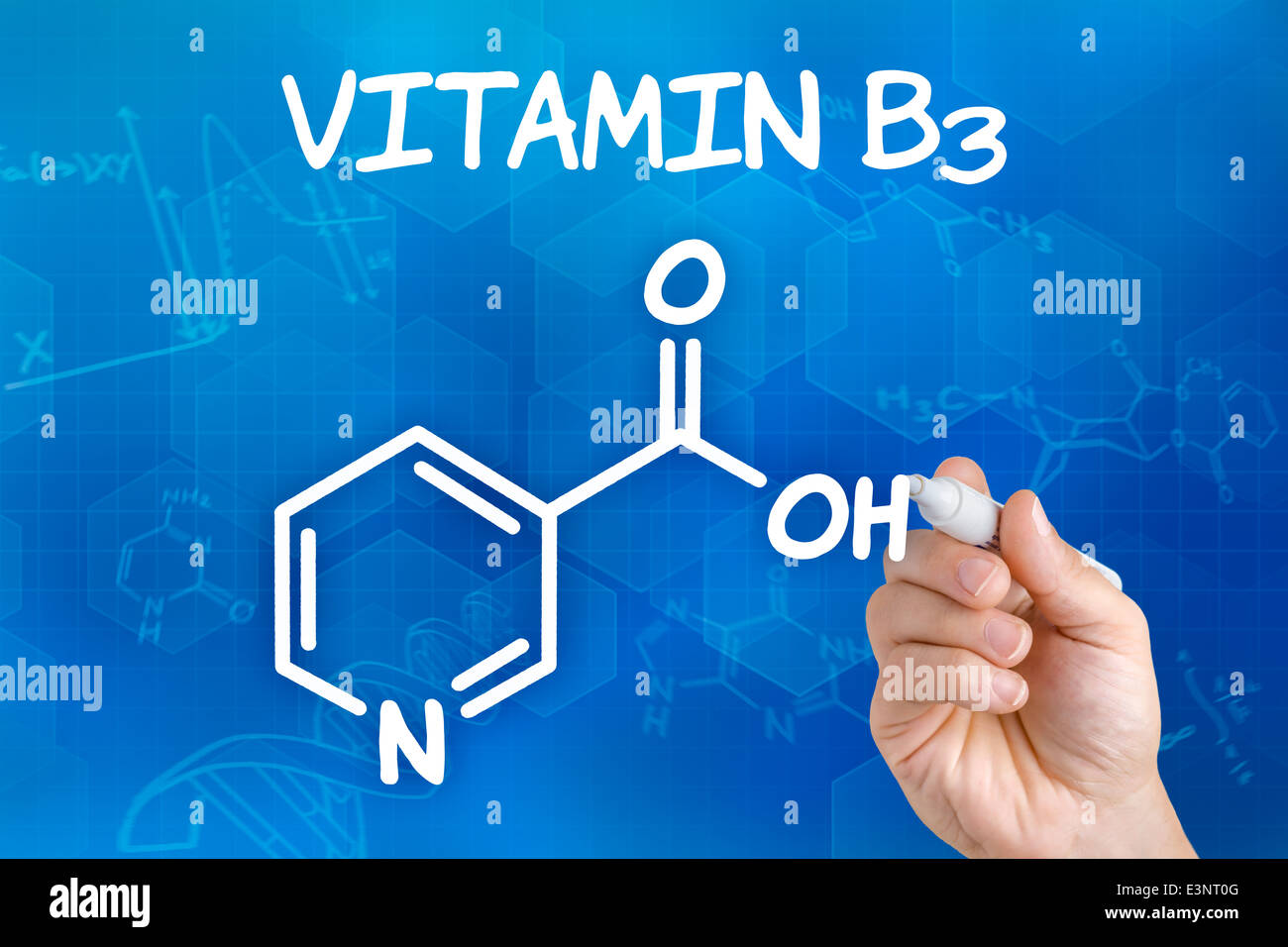 Hand with pen drawing the chemical formula of Vitamin B3 Stock Photo