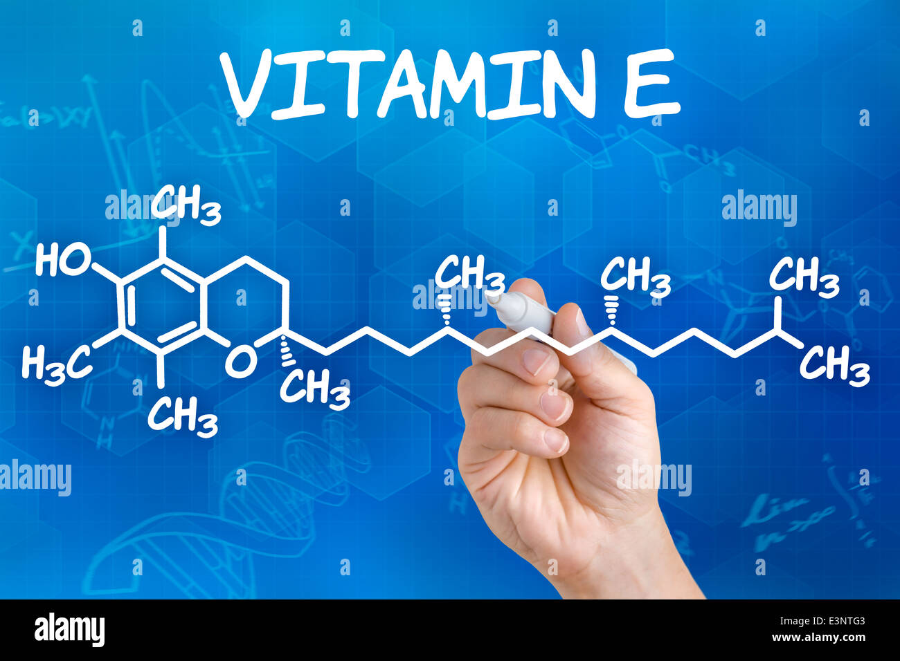 Hand with pen drawing the chemical formula of Vitamin E Stock Photo Alamy