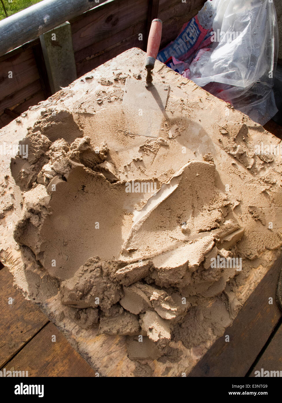 self building house, bricklayers mortar mixing board on scaffolding