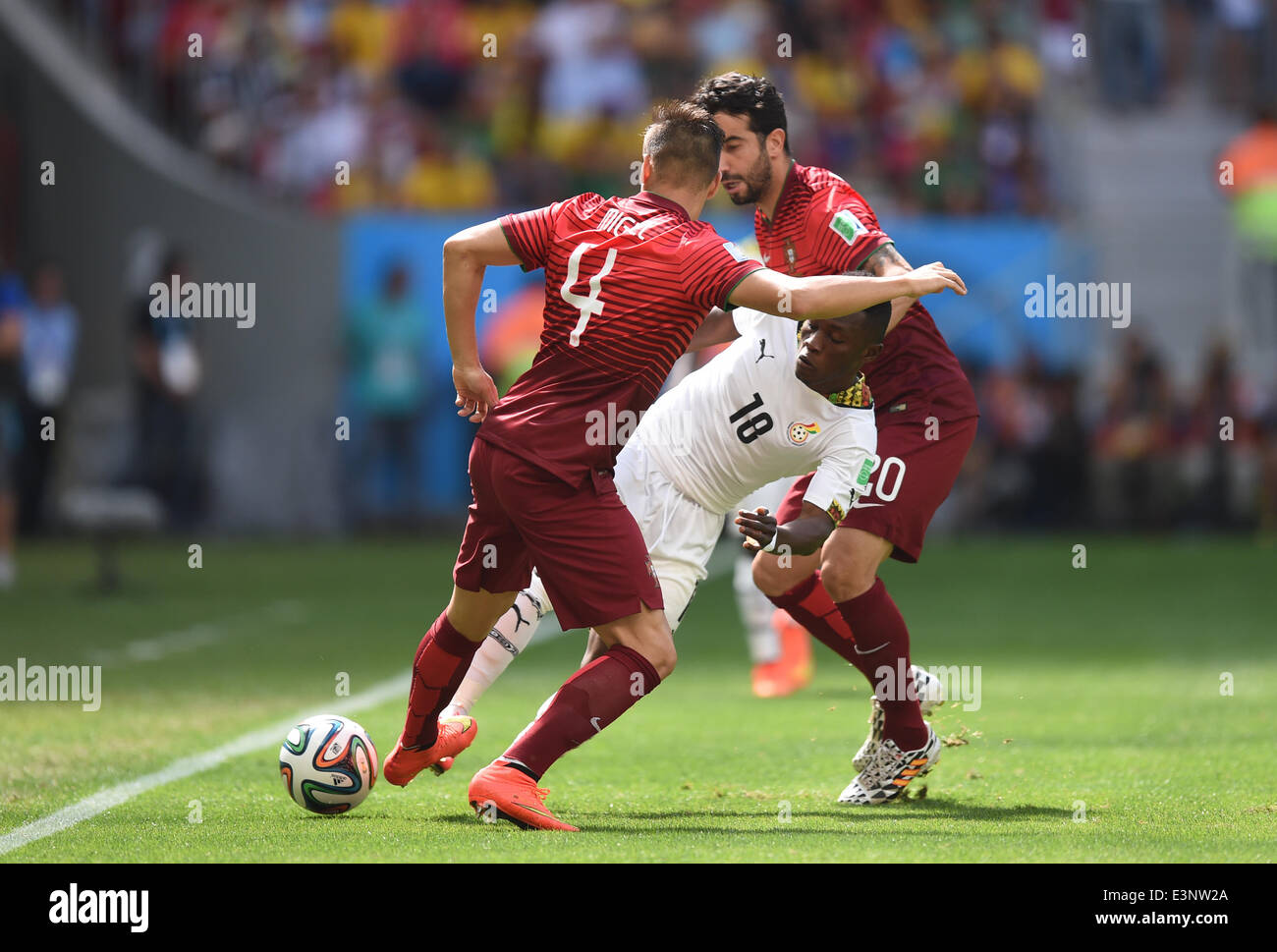 Brasilia, Brazil. 26th June, 2014. Majeed Waris (C) of Ghana in action against Miguel Veloso (L) and Ruben Amorim of Portugal during the FIFA World Cup 2014 group G preliminary round match between Portugal and Ghana at the Estadio National Stadium in Brasilia, Brazil, on 26 June 2014 Credit: © dpa picture alliance/Alamy Live News  Stock Photo