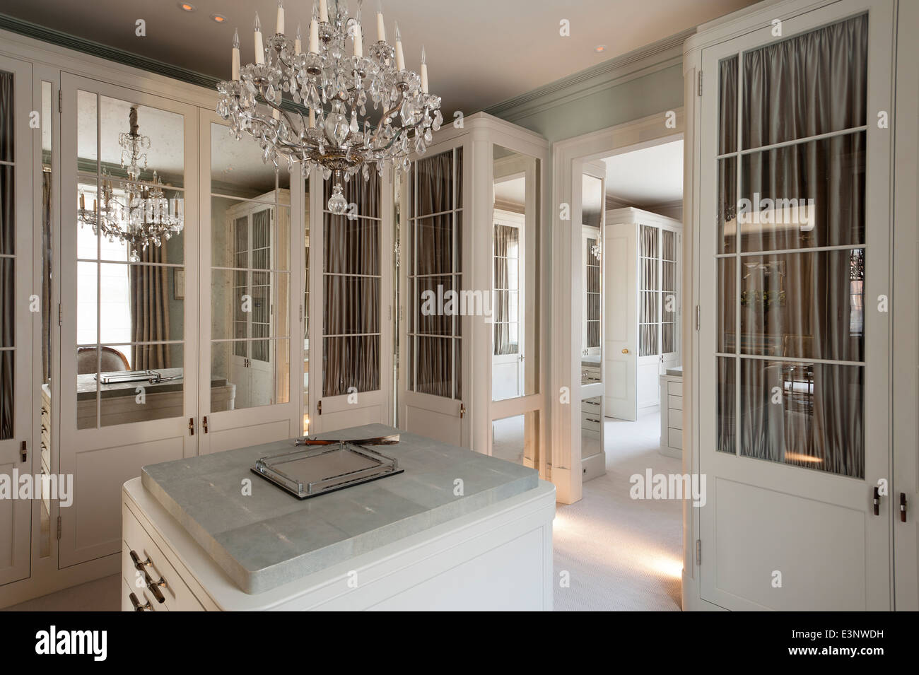 Cut glass chandelier in dressing room with glass and mirror panelled  wardrobes Stock Photo - Alamy