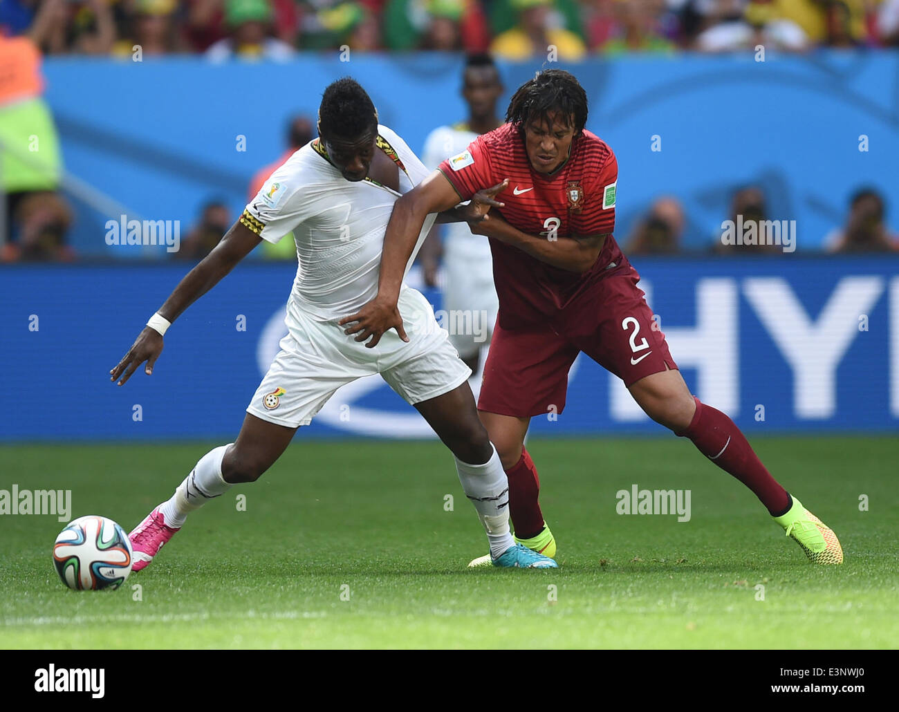 Brasilia, Brazil. 26th June, 2014. Asamoah Gyan (L) of Ghana in action against Bruno Alves of Portugal during the FIFA World Cup 2014 group G preliminary round match between Portugal and Ghana at the Estadio National Stadium in Brasilia, Brazil, on 26 June 2014 Credit: © dpa picture alliance/Alamy Live News  Stock Photo
