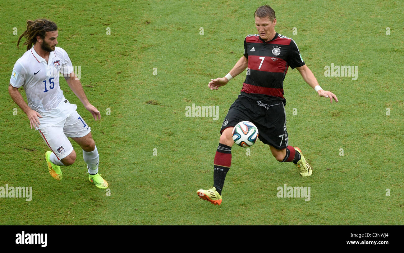 Recife, Brazil. 26th June, 2014. Kyle Beckerman of the USA and Bastian Schweinsteiger (R) of Germany vie for the ball during the FIFA World Cup group G preliminary round match between the USA and Germany at the Arena Pernambuco in Recife, Brazil, 26 June 2014. Photo: Andreas Gebert/dpa/Alamy Live News Stock Photo