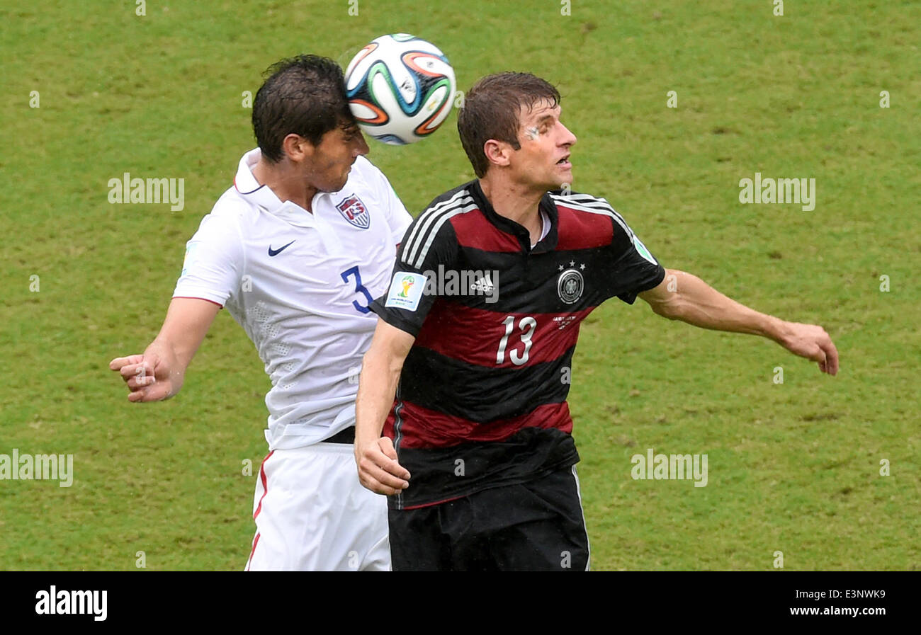 Recife, Brazil. 26th June, 2014. Omar Gonzalez of the USA and Thomas Mueller (R) of Germany vie for the ball the ball during the FIFA World Cup group G preliminary round match between the USA and Germany at the Arena Pernambuco in Recife, Brazil, 26 June 2014. Photo: Andreas Gebert/dpa/Alamy Live News Stock Photo