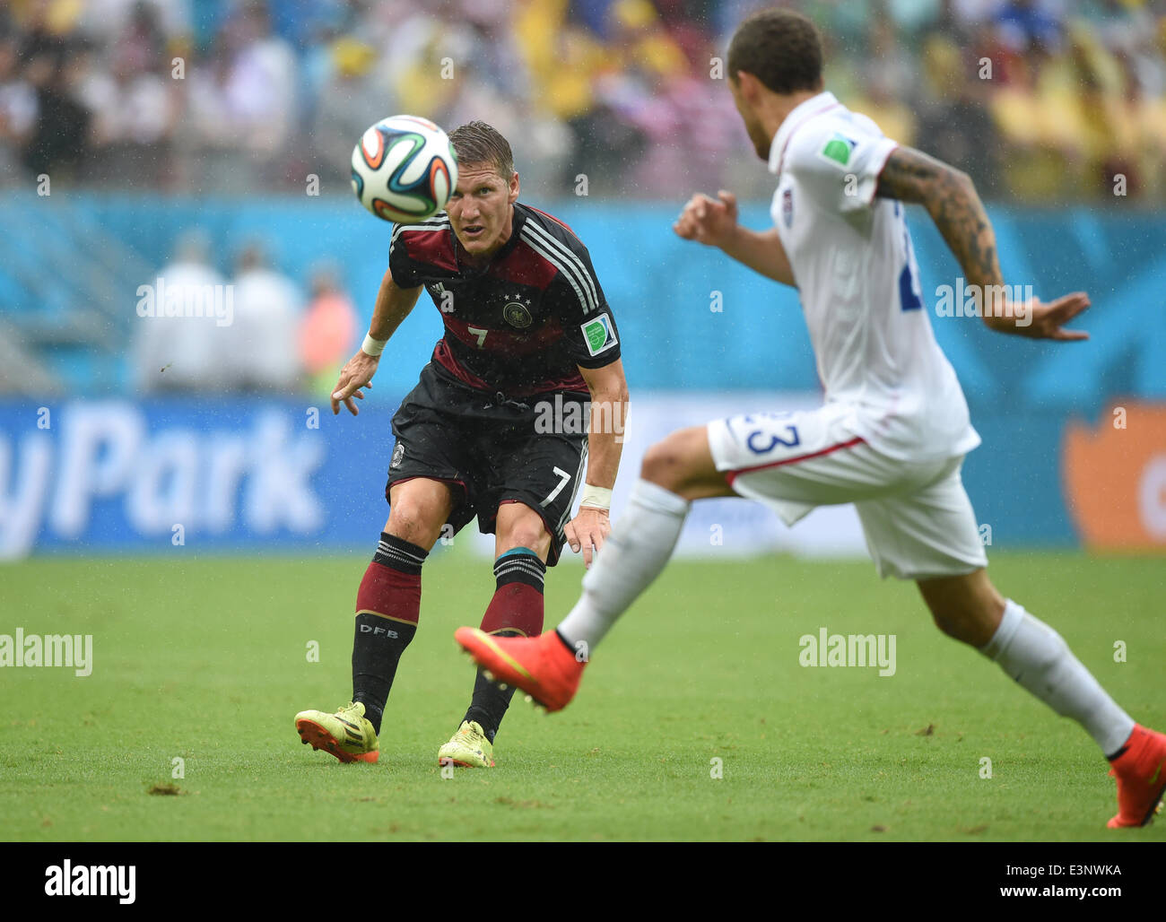 Recife, Brazil. 26th June, 2014. Germany's Bastian Schweinsteiger (L) and Fabian Johnson of the US vie for the ball during the FIFA World Cup group G preliminary round match between the USA and Germany at Arena Pernambuco in Recife, Brazil, 26 June 2014. Photo: Marcus Brandt/dpa/Alamy Live News Stock Photo