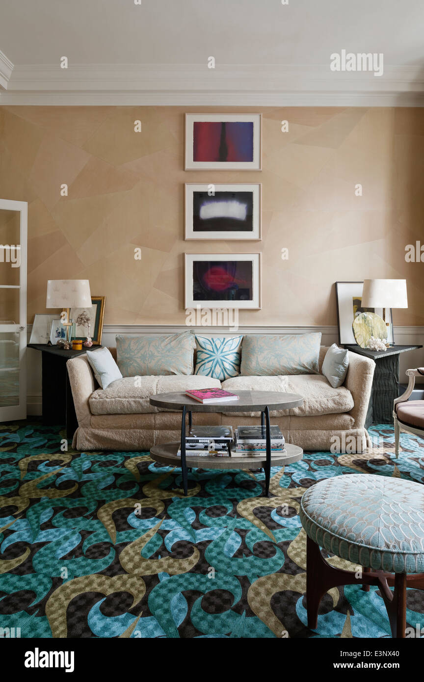 Large sofa in drawing room with bright rug designed by Allegra Hicks Stock Photo