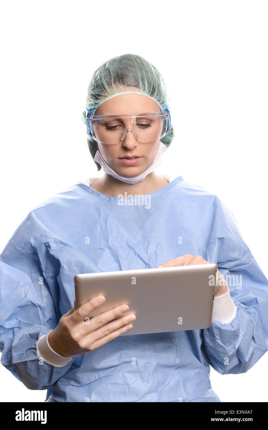 Doctor in scrubs entering data on a tablet computer Stock Photo