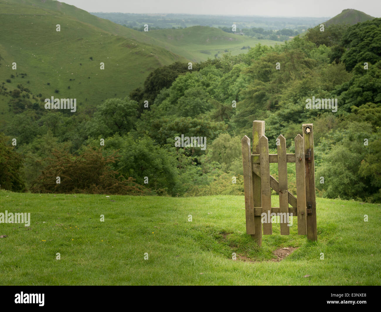 Gateway without a fence at the top of hill is a puzzling, hilarious sight. Stock Photo