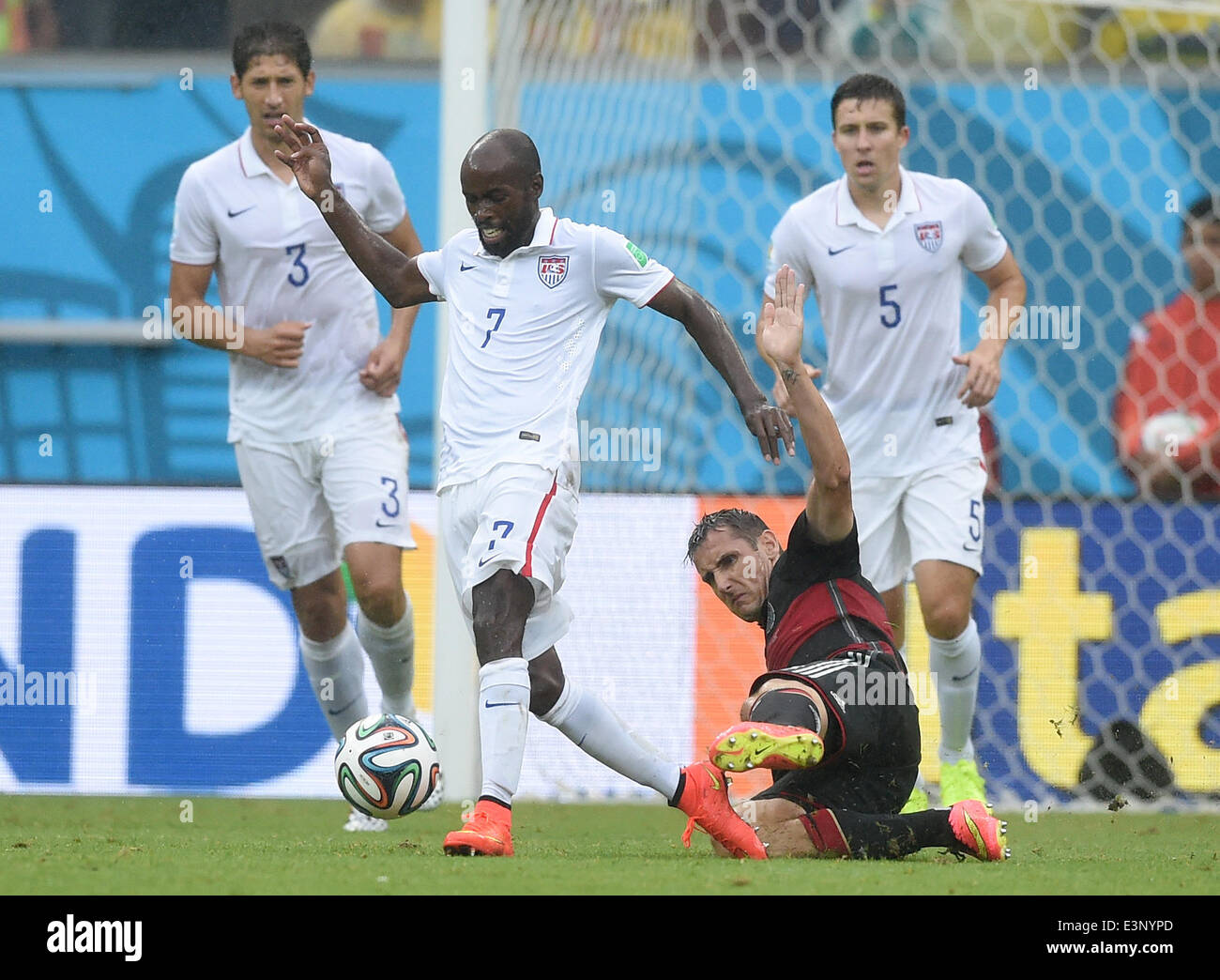 Recife, Brazil. 26th June, 2014. Germany's Miroslav Klose vies for the ball with Omar Gonzalez (L-R), DaMarcus Beasley and Matt Besler of the US during the FIFA World Cup group G preliminary round match between the USA and Germany at Arena Pernambuco in Recife, Brazil, 26 June 2014. Photo: Marcus Brandt/dpa/Alamy Live News Stock Photo
