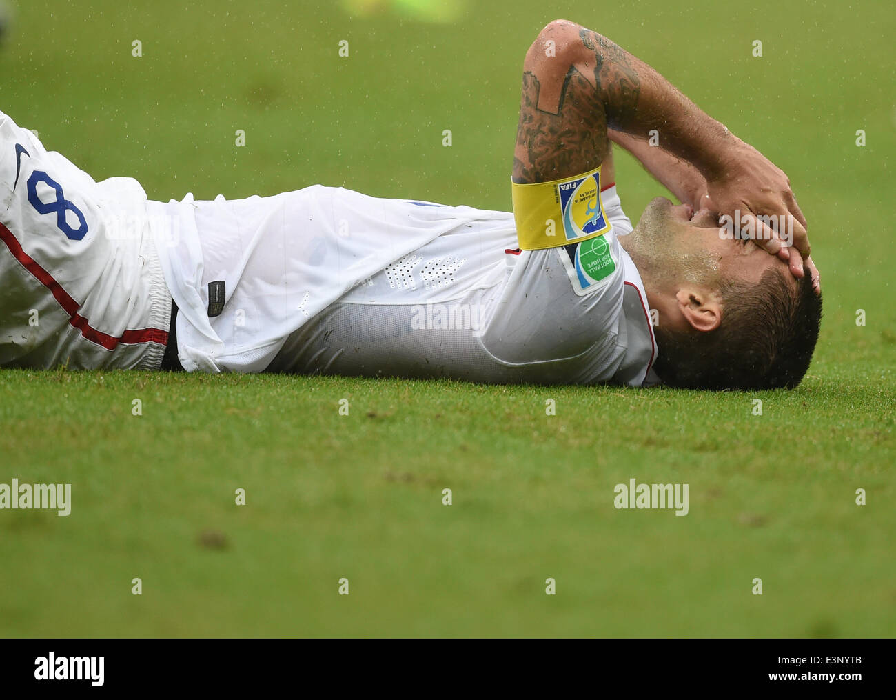 Recife, Brazil. 26th June, 2014. Clint Dempsey of the US lies on the pitch during the FIFA World Cup group G preliminary round match between the USA and Germany at Arena Pernambuco in Recife, Brazil, 26 June 2014. Photo: Marcus Brandt/dpa/Alamy Live News Stock Photo